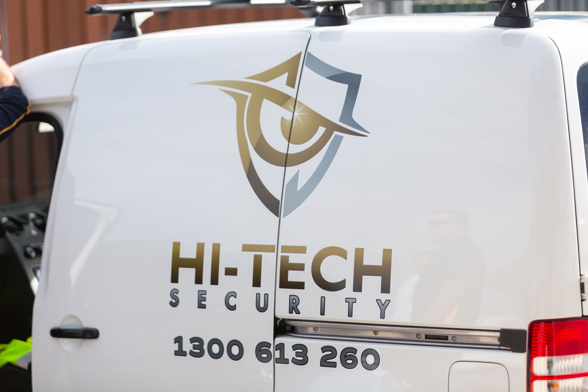 Hi-Tech Security service van with the company logo and phone number